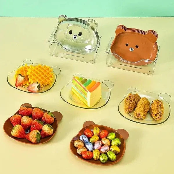 Set of bear-shaped dessert plates with various treats on a light green background
