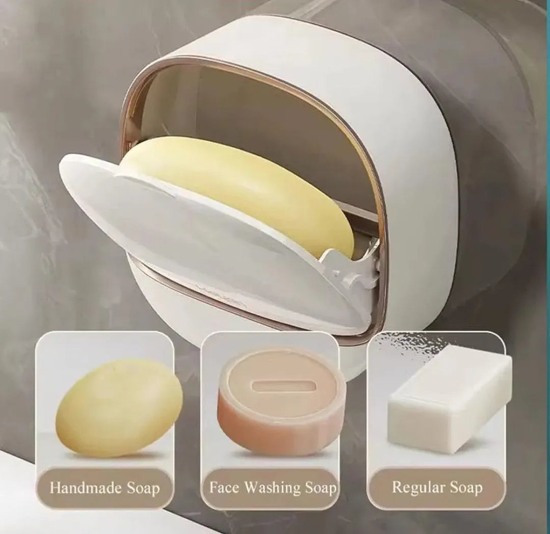 A wall-mounted soap dispenser holding a pale yellow bar of soap, with three inset examples below showing handmade soap, face washing soap, and regular soap.