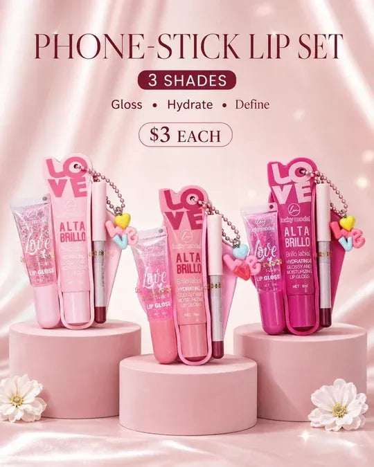 Three pink phone-stick lip sets displayed on pink pedestals against a soft pink satin background. The sets include gloss, hydrate, and define items with 'LOVE' keychains and tubes labeled 'ALTA BRILLO' and 'LOVE'.
