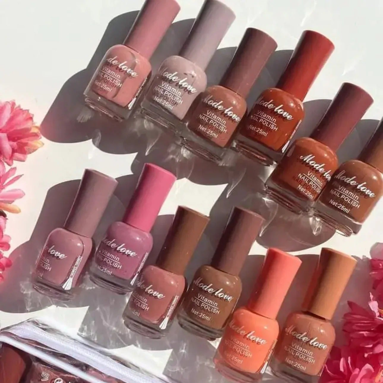 Set of nail polish bottles with a clear stand against a light background 