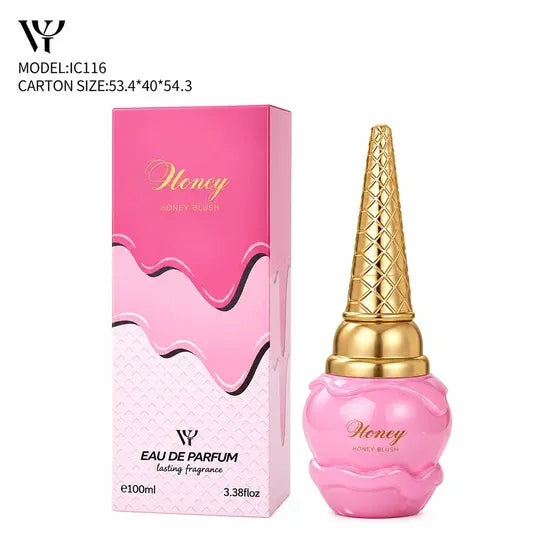 Pink and gold Honey Eau De Parfum bottle next to its pink packaging box, featuring a dripping pink design and gold lettering, on a white background.