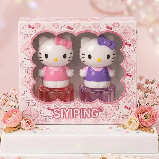 A boxed pair of Hello Kitty-themed SIMPING hair color bottles displayed on a white stand with pink flowers and confetti. The packaging shows two Hello Kitty figures, one in pink and one in purple, with the SIMPING brand name visible on the front.