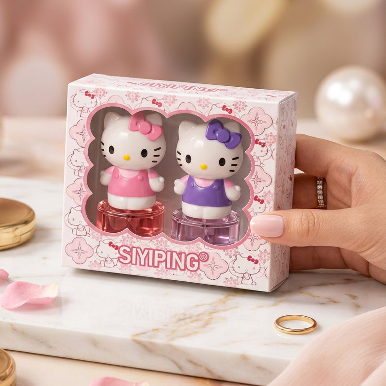 Hello kitty A hand holds a pink Hello Kitty themed SIMPING gift box containing two small character-shaped items, one in pink and one in purple, against a pink heart-patterned background.