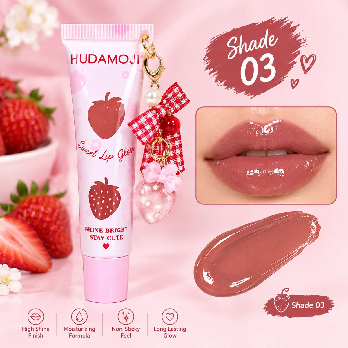 Hudamoji Sweet Lip Glow tube in shade 03, featuring a strawberry design on a pink background with a lip application inset, a lip gloss smear, and strawberry props.