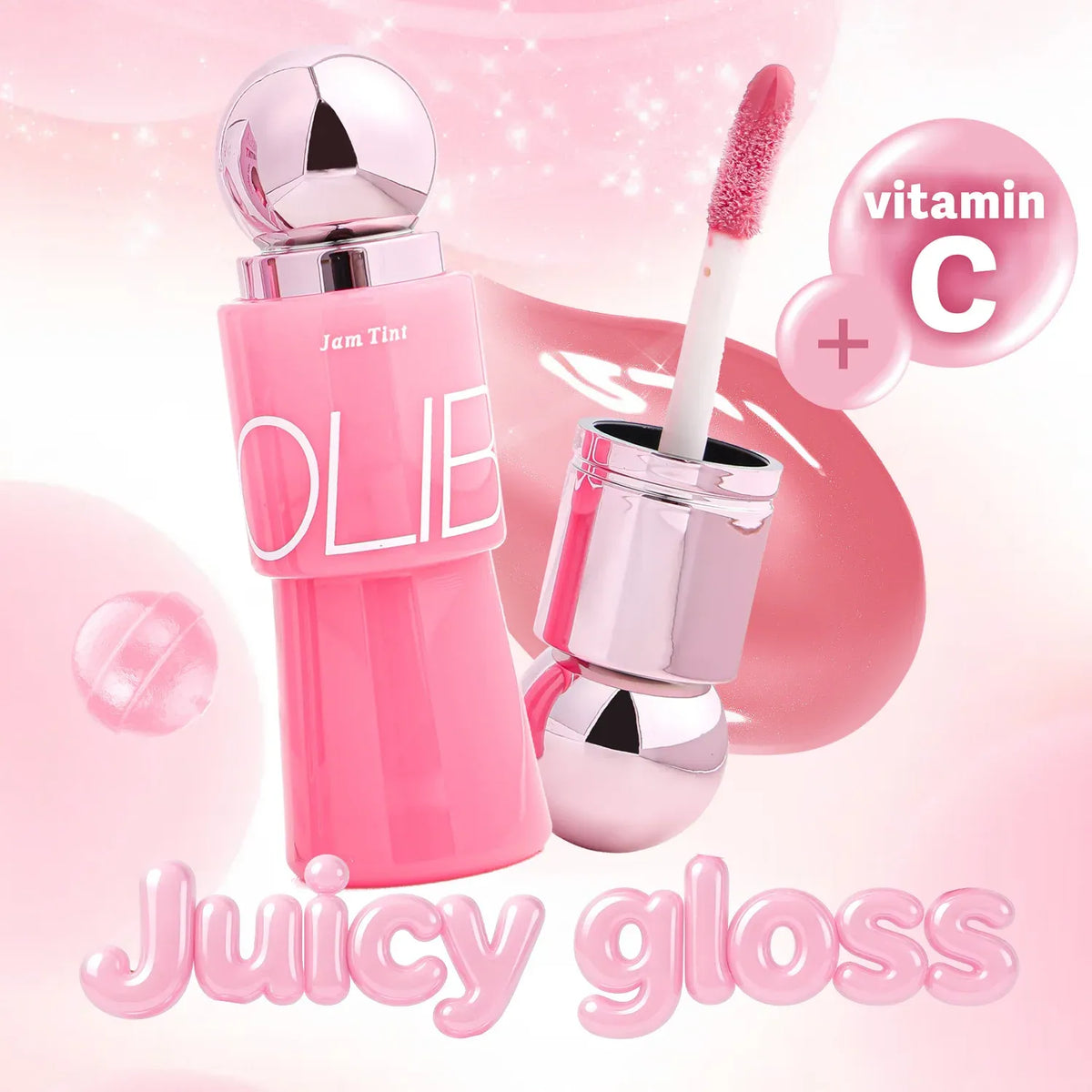 A pink cosmetic gloss bottle with a reflective silver cap and applicator wand, shown on a soft pink background with text reading 'Juicy gloss' and 'vitamin C'.