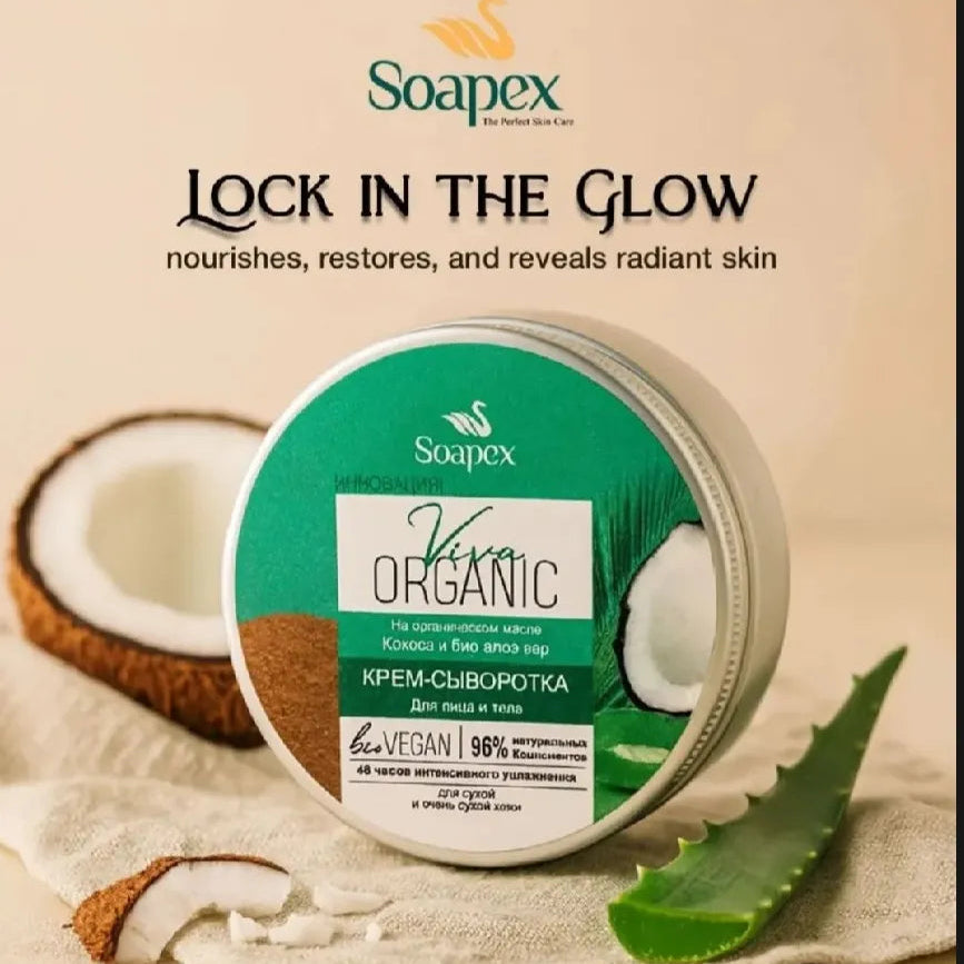 A round tin of Soapex Viva Organic Shea Butter shown on a beige background with a coconut half, aloe vera leaf, and a cloth. The product label is green and white, and the ad includes the text 'LOCK IN THE GLOW' and 'nourishes, restores, and reveals radiant skin'.