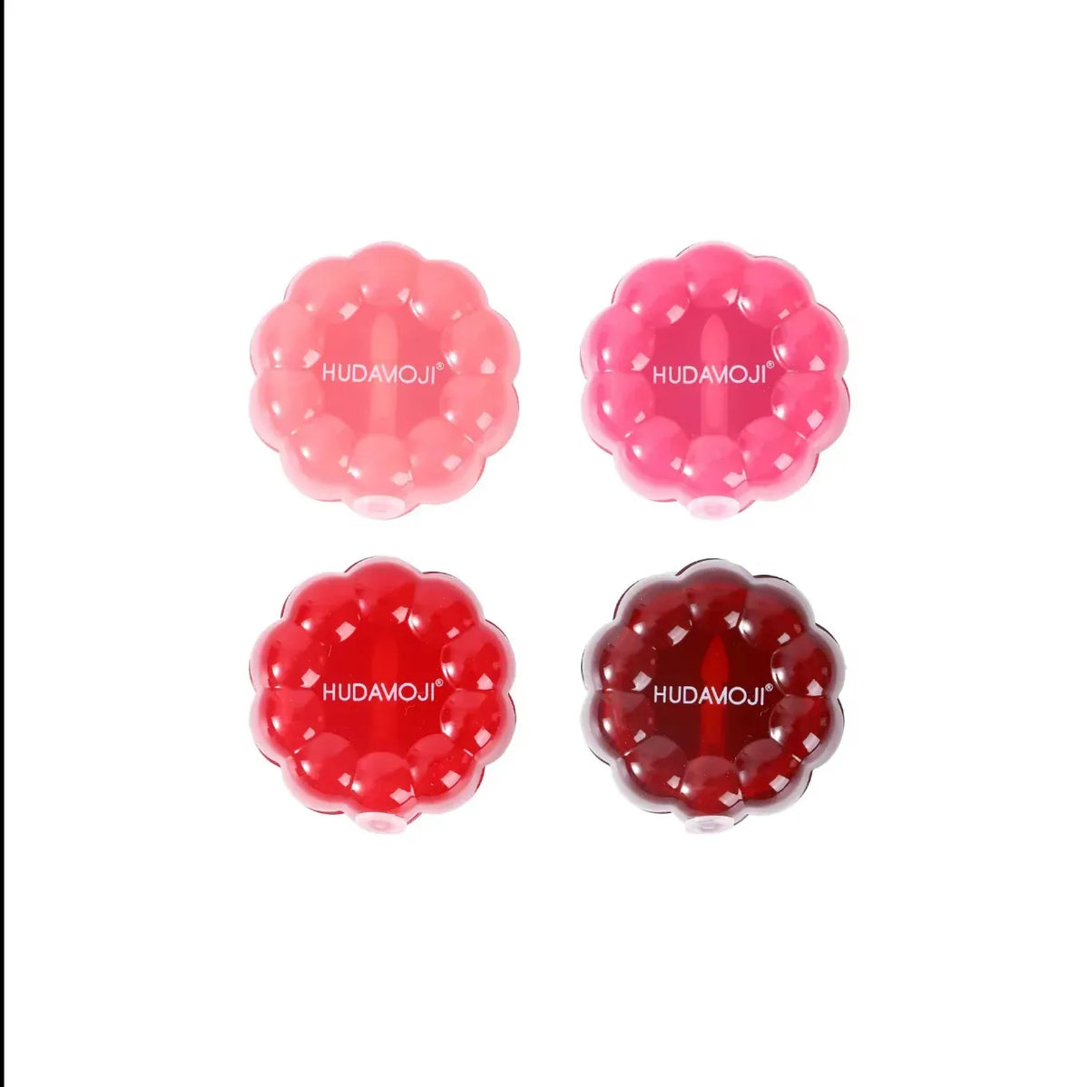 Four flower-shaped translucent cosmetic gel pads in pink, coral, red, and burgundy shades, arranged in a 2x2 grid on a white background. Each pad features the white text 'HUDAMOJI' in the center.